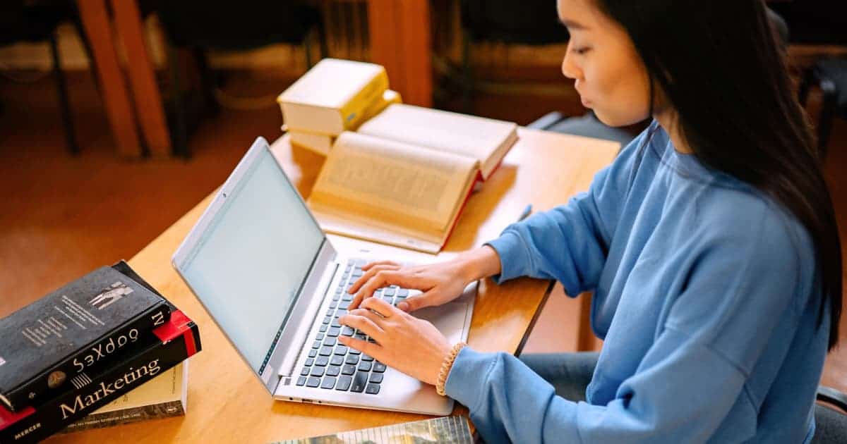 A student submitting an online college application.