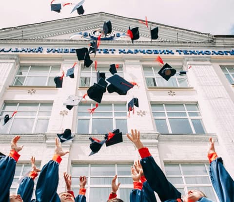 Students celebrating their graduation and scholarships for better financial planning for college.