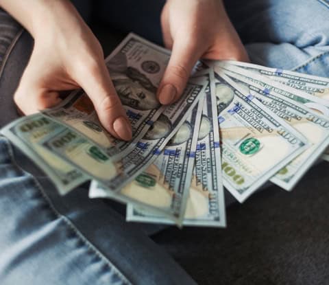 man counting money to figure out if he’ll be able to afford college in the us