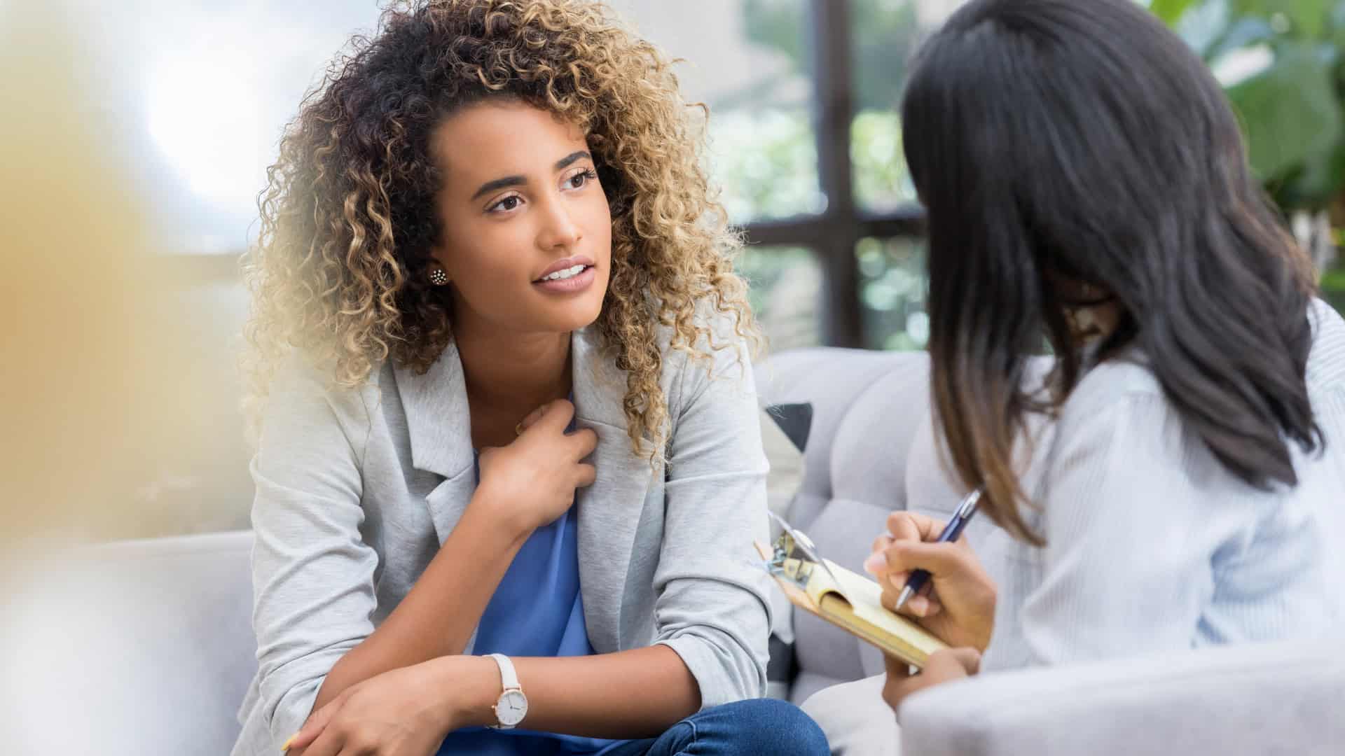 student sitting and taking advice from a college admission counselor