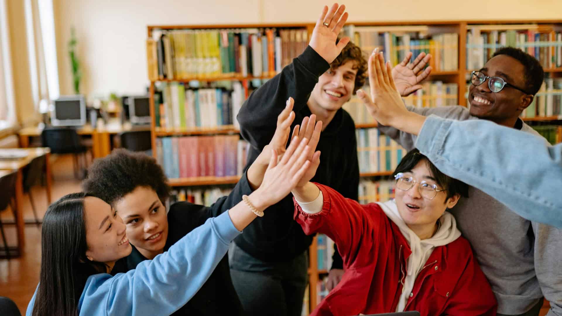 group of students celebrating getting accepted into college