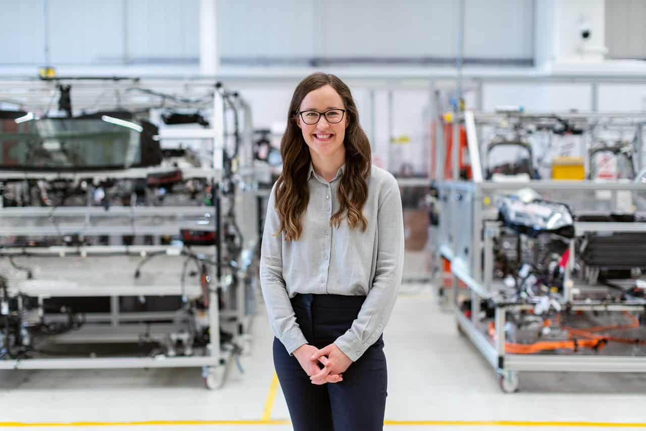 Smiling student in a professional setting, representing hands-on experience through a college co-op program in engineering.
