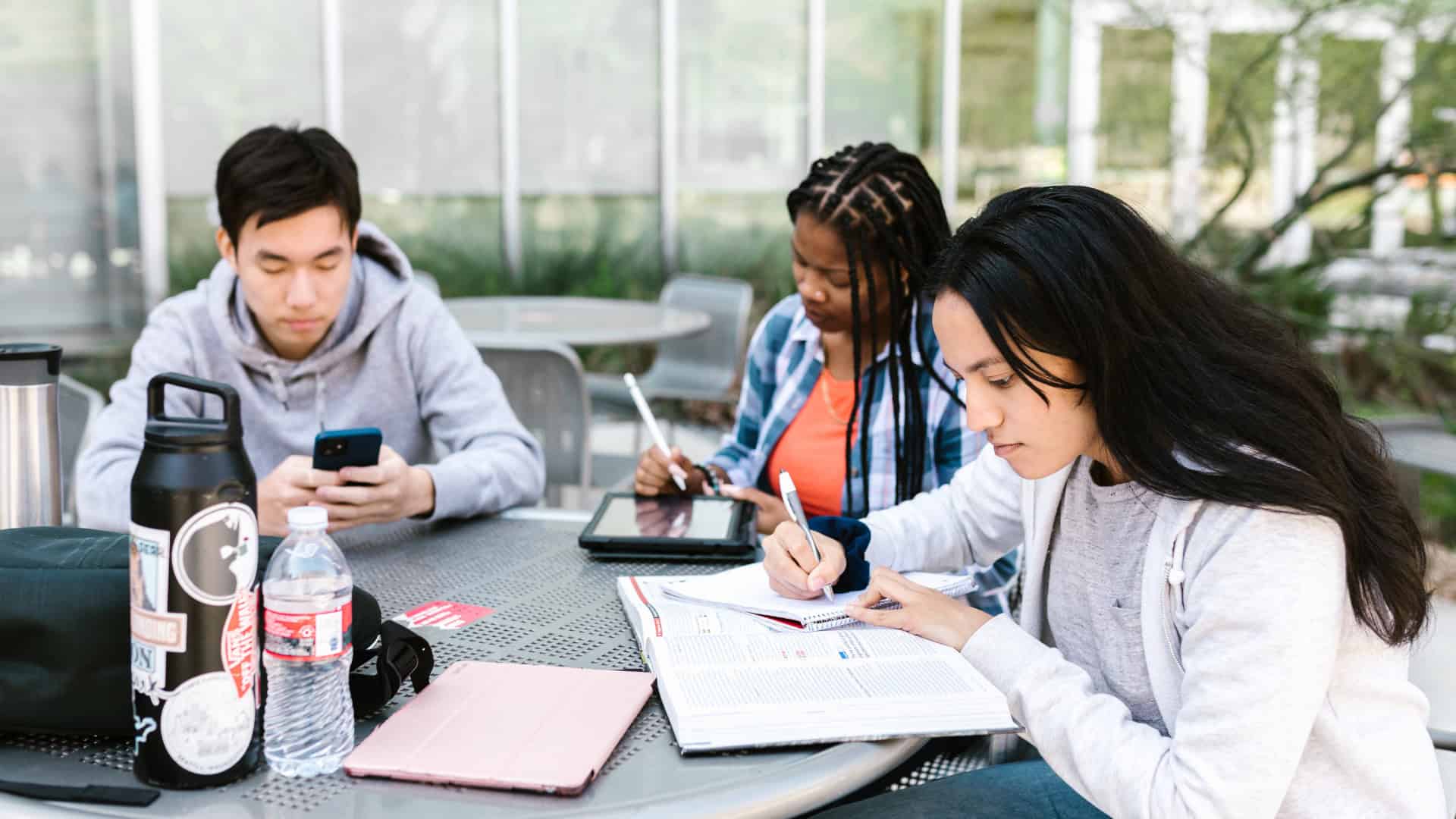 a group of students studying at a cafeteria balancing their studies and enjoyment