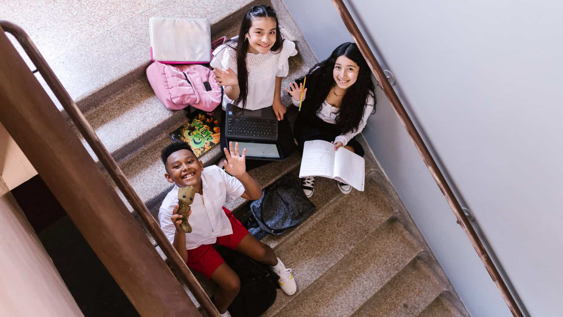 a group of students sitting and enjoying on the stairs