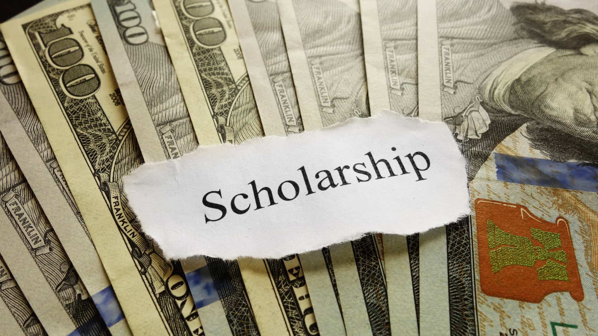 bunch of notes laid out on table with a slip of scholorship