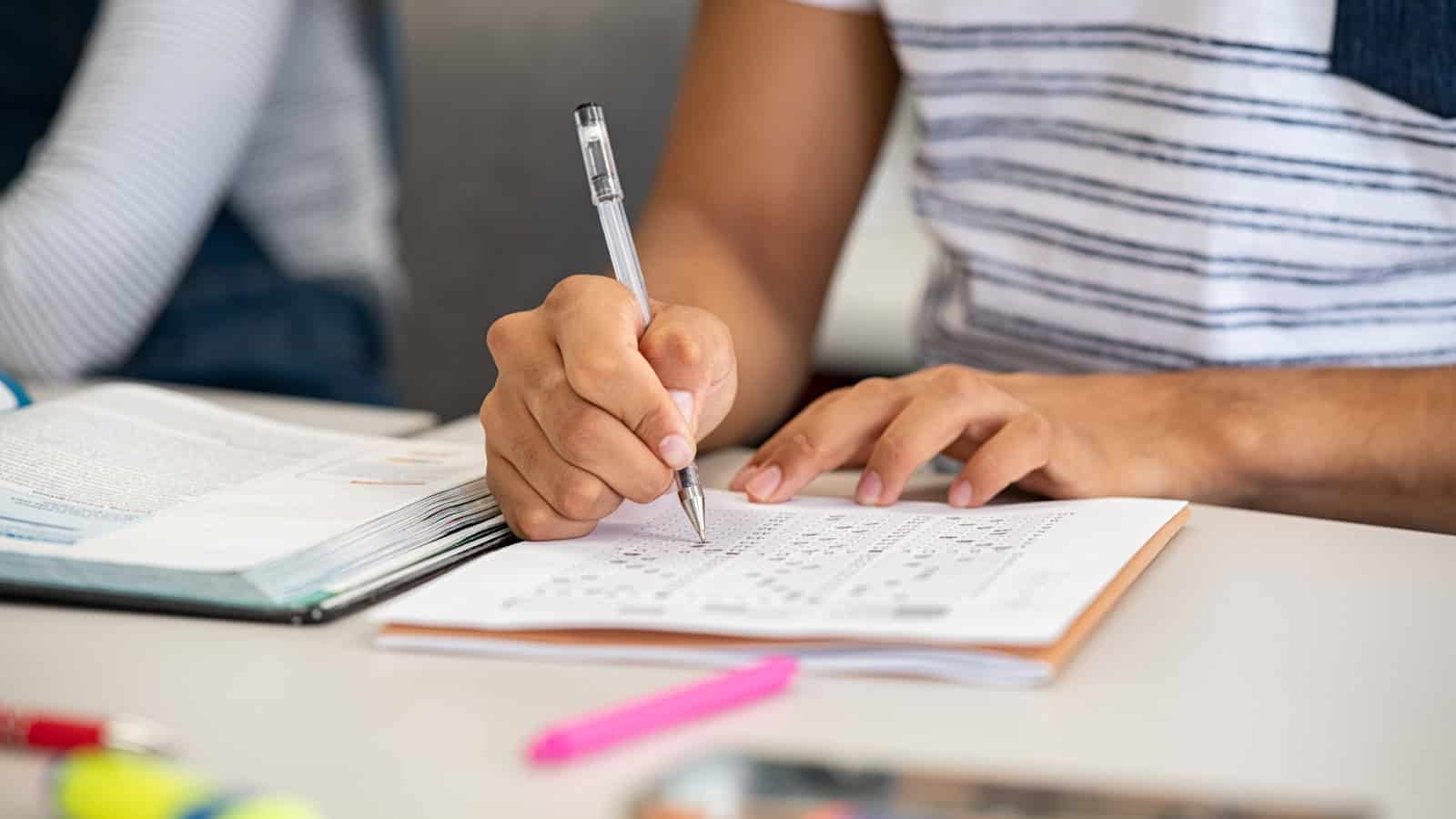 Student filling the omr sheet answers for meeting the minimum gpa requirement